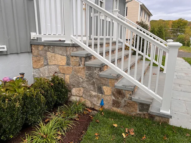 a view of building with yard and staircase