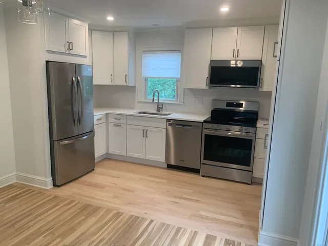 a kitchen with a sink and a stove top oven