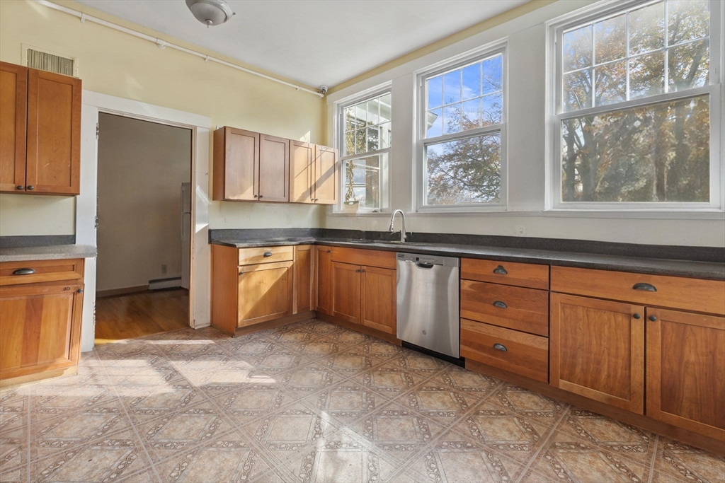 5 Claremont Street Worcester, MA 01610 - Photo 17 of 42 a large kitchen with granite countertop a sink window and stainless steel appliances