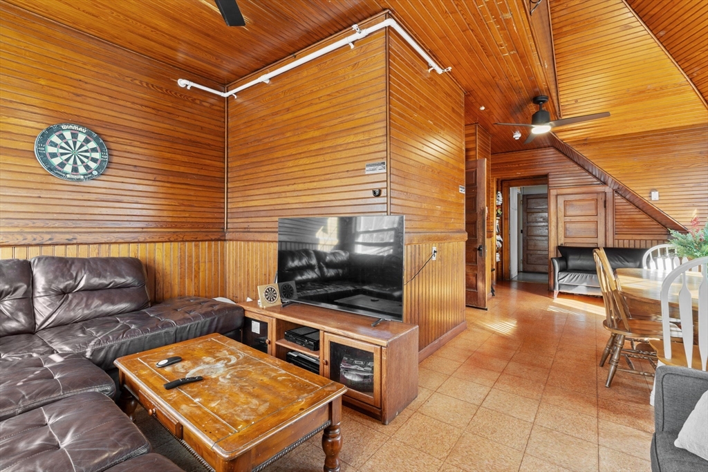 5 Claremont Street Worcester, MA 01610 - Photo 21 of 42 a living room with furniture a flat screen tv and kitchen view