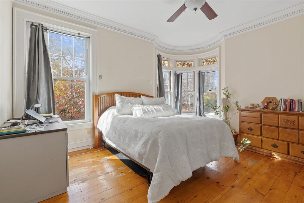 5 Claremont Street Worcester, MA 01610 - Photo 26 of 42 a bedroom with a bed and large windows