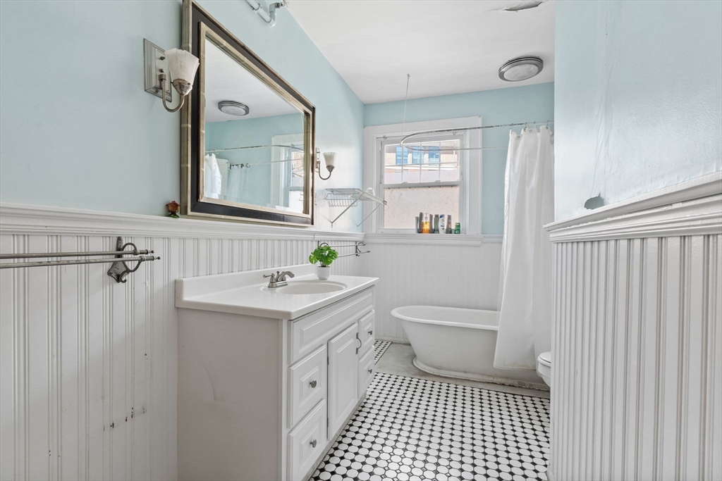 5 Claremont Street Worcester, MA 01610 - Photo 31 of 42 a bathroom with a sink a toilet and window