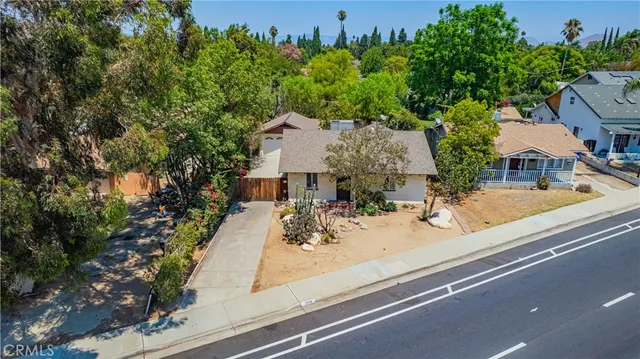 an aerial view of a house with garden space and street view