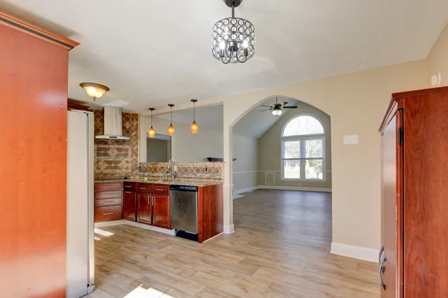 a view of living room and kitchen with furniture wooden floor and window
