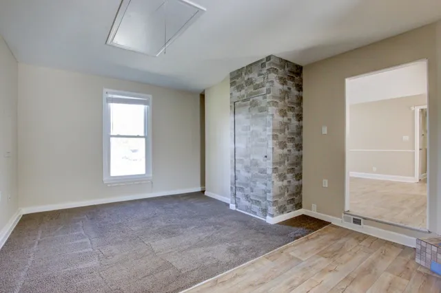 an empty room with windows and mountain view