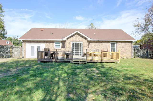 a backyard of a house with table and chairs