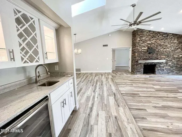 a kitchen with granite countertop a sink stove and cabinets
