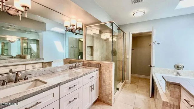 a spacious bathroom with a granite countertop sink mirror and double