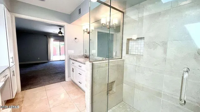 a bathroom with a double vanity sink a mirror and a shower