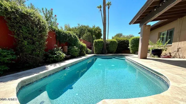 a swimming pool with outdoor seating and yard