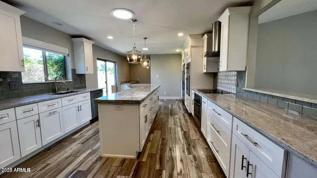 a large kitchen with granite countertop lots of counter space and window