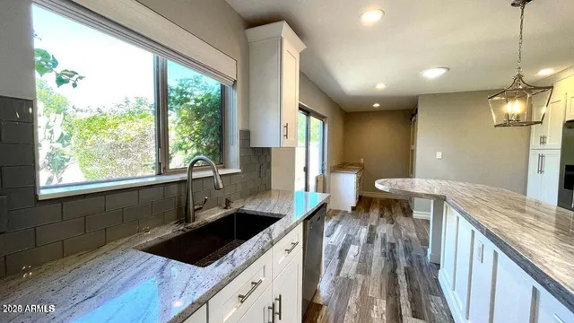 a kitchen with a sink and wooden cabinets