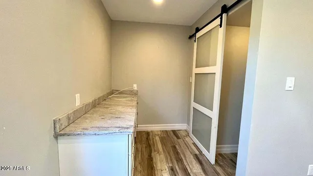 a bathroom with a granite countertop shower and a sink
