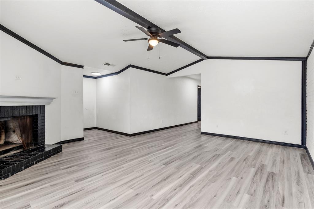 2802 Spring Valley Drive Bedford, TX 76021 - Photo 12 of 24 a view of a livingroom with wooden floor and a fireplace
