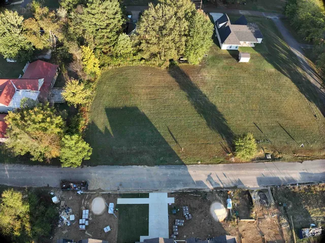 an aerial view of a house with a yard