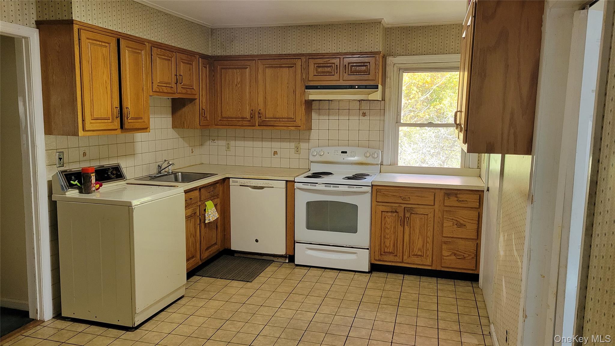 2 Stephens Lane Valhalla, NY 10595 - Photo 3 of 9 a kitchen with a stove sink and cabinets