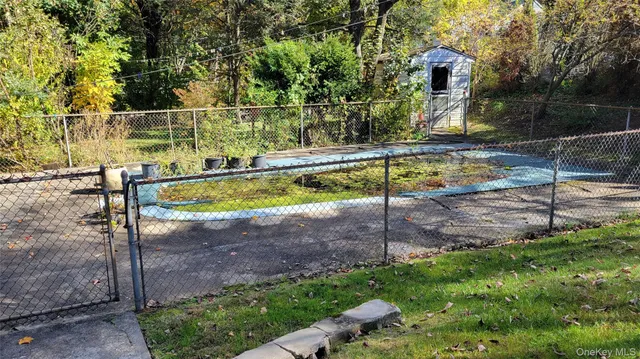 a view of a backyard with swimming pool