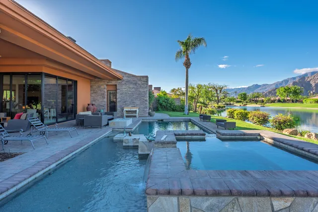 a view of a patio with chairs and potted plants