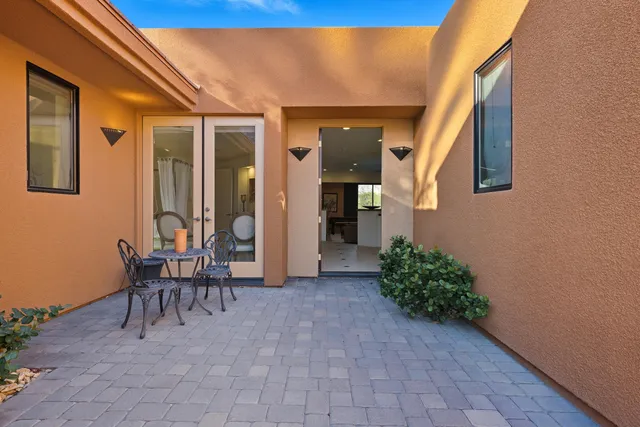 a view of a patio with chairs and tables