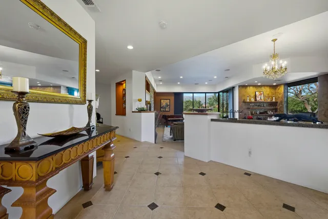 a view of a kitchen with kitchen island stainless steel appliances sink stove and cabinets