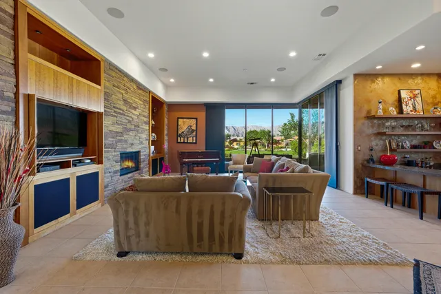 a living room with fireplace furniture and a flat screen tv