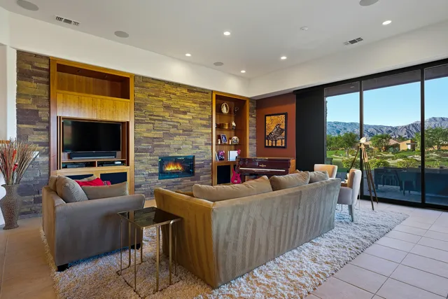 a living room with fireplace furniture and a flat screen tv