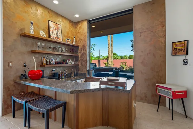 a room with furniture a flat screen tv and a floor to ceiling window