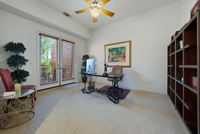 a view of a livingroom with workspace and a window
