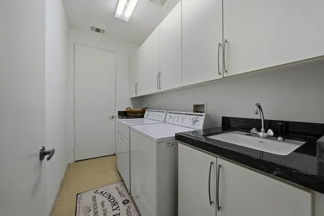a utility room with sink dryer and washer