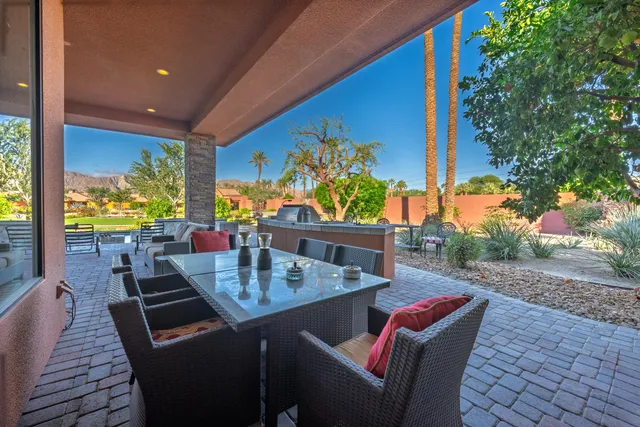 a dining room with furniture and a potted plant