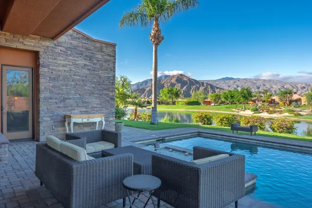 a patio area with couch and city view