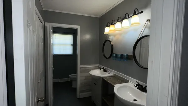a bathroom with a sink double vanity and a mirror
