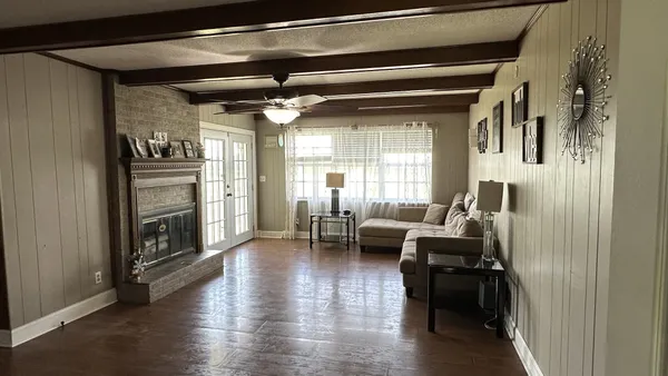 a living room with furniture and a fireplace