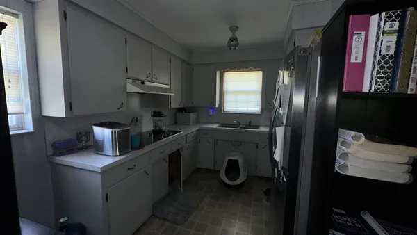 a kitchen with stainless steel appliances a sink stove and refrigerator