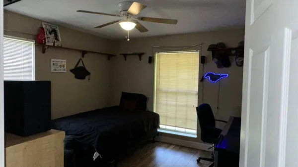 a bedroom with a bed and a bookshelf