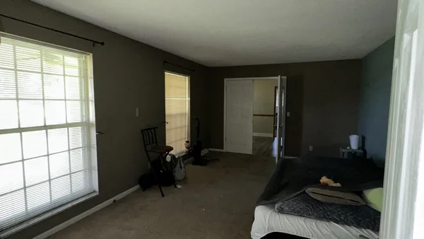 a room with gym equipment and a large window