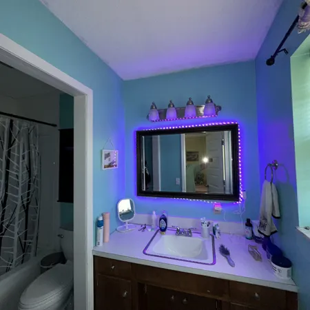 a bathroom with a sink mirror and vanity