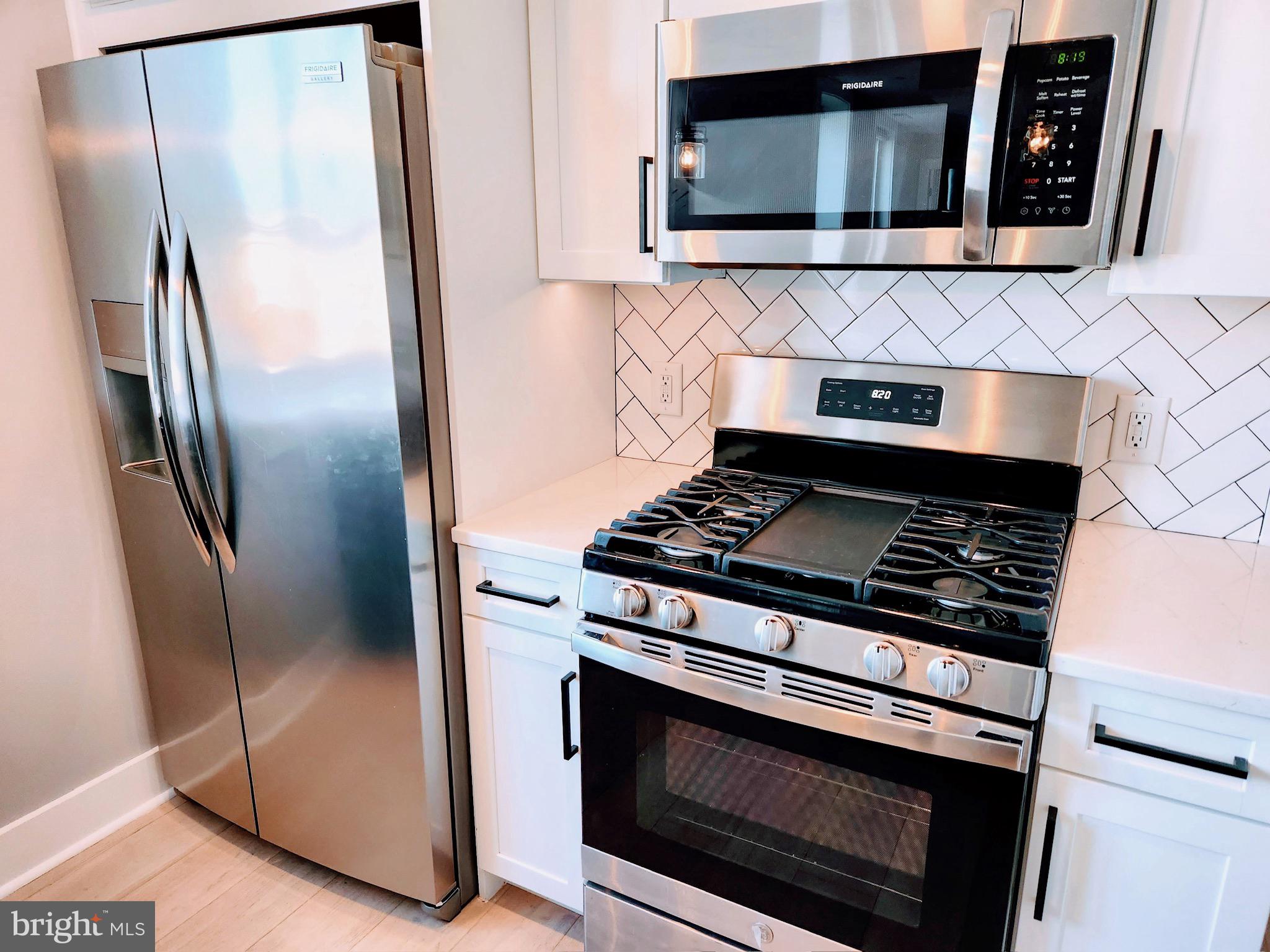 1915 H Street Northeast Washington, DC 20002 - Photo 3 of 14 a stove top oven sitting inside of a kitchen