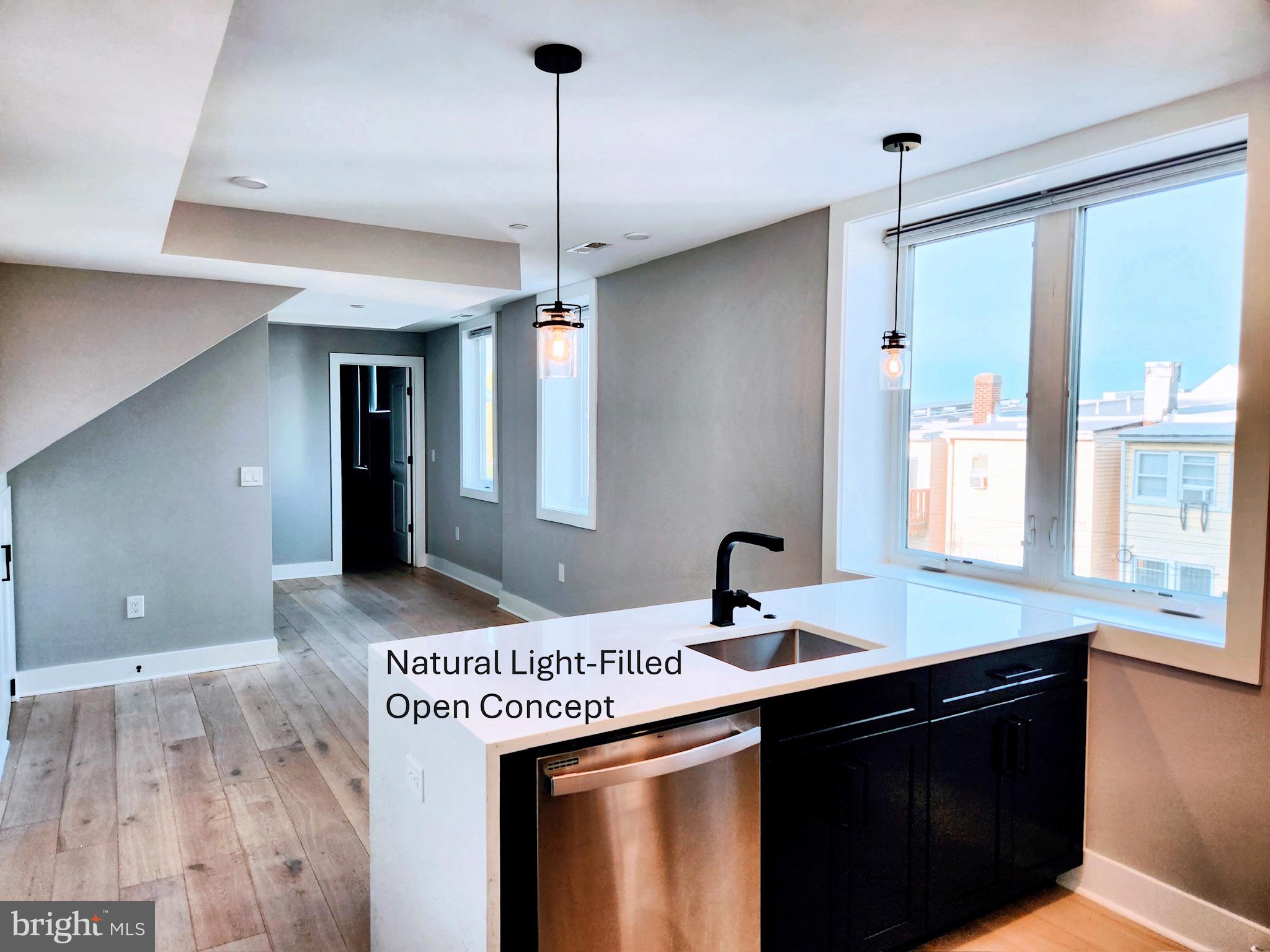 1915 H Street Northeast Washington, DC 20002 - Photo 4 of 14 a kitchen with a sink a counter space and a chandelier