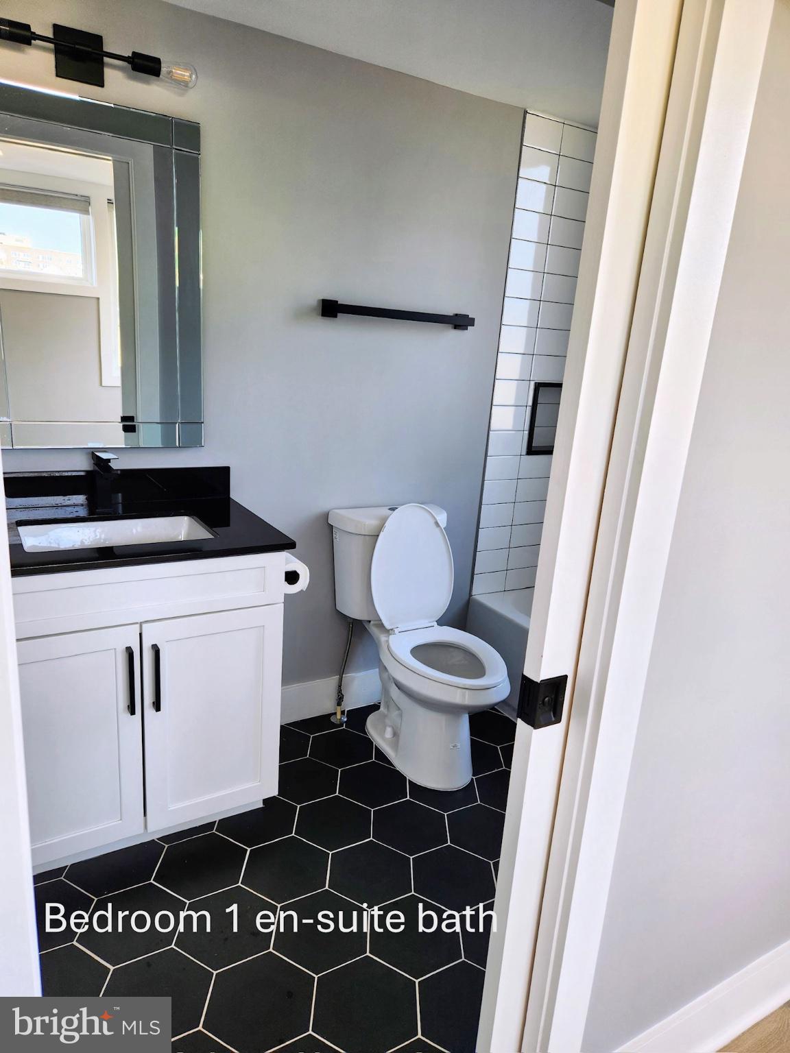 1915 H Street Northeast Washington, DC 20002 - Photo 8 of 14 a bathroom with a toilet a sink and a window
