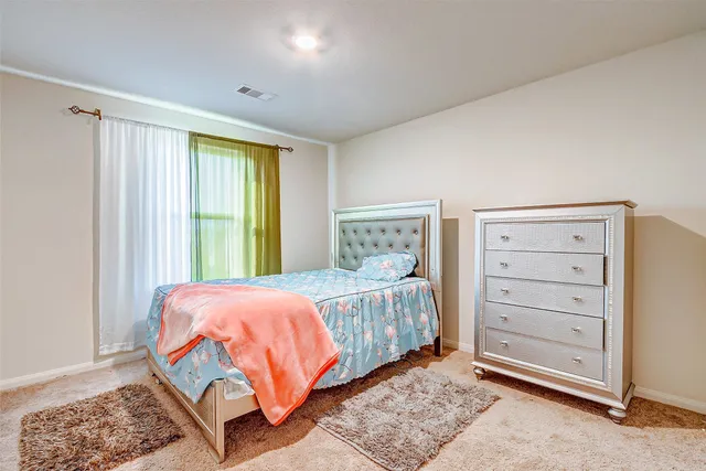 a bedroom with a bed and a window