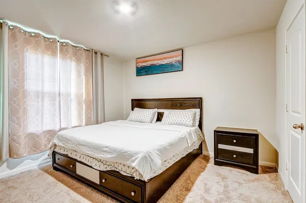 a bedroom with a bed and a dresser