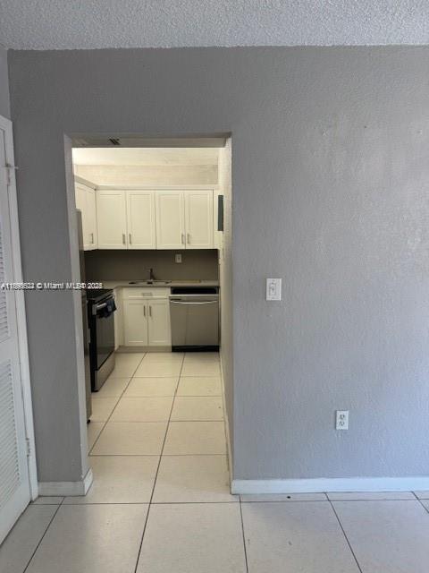 17530 Northwest 68th Avenue, Unit C2004 Hialeah, FL 33015 - Photo 2 of 6 a kitchen with a cabinets and white appliances