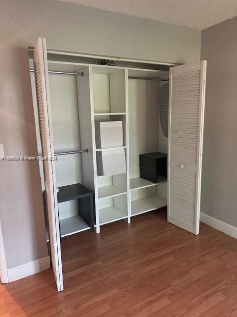 17530 Northwest 68th Avenue, Unit C2004 Hialeah, FL 33015 - Photo 5 of 6 a walk in closet with wooden floor