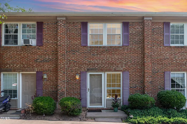 a front view of a brick house with a large windows