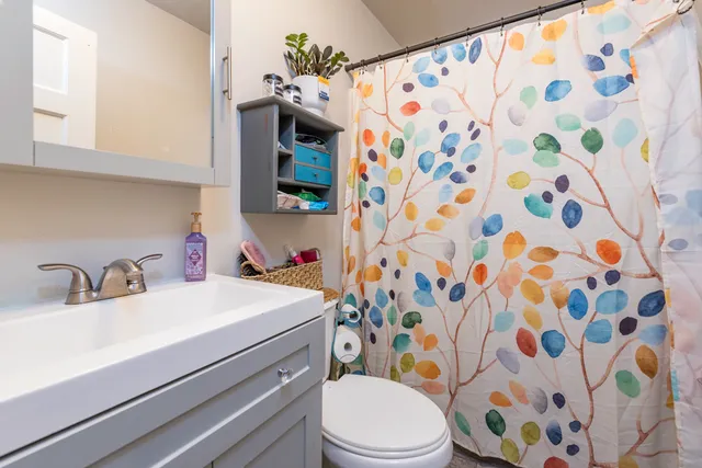 a bathroom with a sink toilet and shower