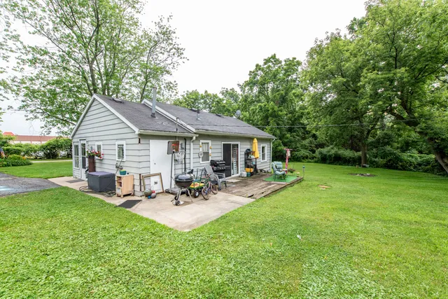 a view of a house with backyard and a slide