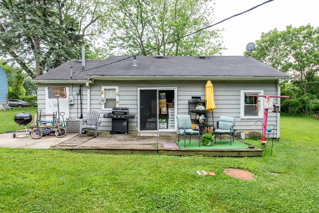 a front view of house with yard and outdoor seating