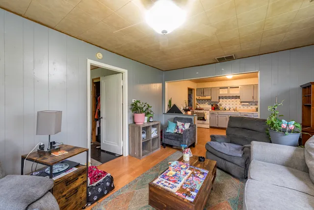 a living room with furniture a rug and a lamp