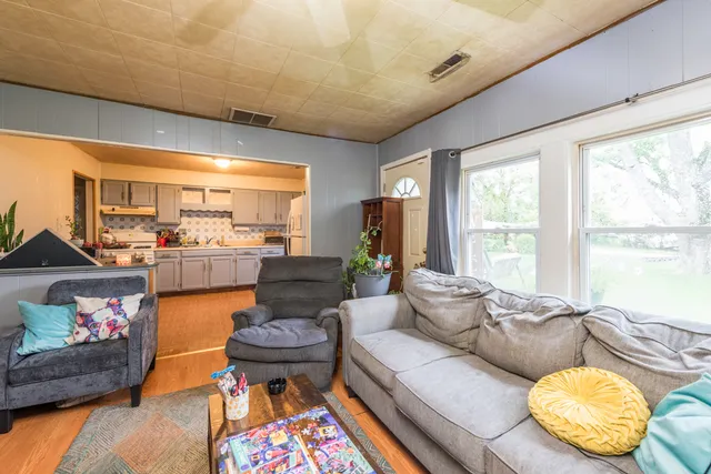 a living room with furniture and a large window